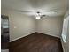 Spacious living room features hardwood floors, a ceiling fan, and plenty of natural light at 9107 Morris Sw Dr, Covington, GA 30014