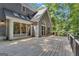 Back deck features a gray exterior, large sliding doors, and a partial view of wooded backyard at 425 Birkdale Dr, Fayetteville, GA 30215
