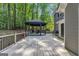 Wooden back deck leading to a gazebo with backyard views of the surrounding forest at 425 Birkdale Dr, Fayetteville, GA 30215