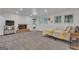 Carpeted basement bedroom features a brick fireplace, large windows, and access to the outside at 425 Birkdale Dr, Fayetteville, GA 30215