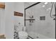 Modern bathroom showcasing a glass shower, sleek fixtures, and witty signage for a clean and inviting space at 425 Birkdale Dr, Fayetteville, GA 30215