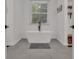 Sleek bathroom showcasing a freestanding tub, tile floors, and ample natural light from a window, creating a spa-like feel at 425 Birkdale Dr, Fayetteville, GA 30215