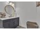 Modern bathroom featuring a dark vanity, round mirror, and neutral walls; a stylish and functional space at 425 Birkdale Dr, Fayetteville, GA 30215