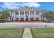 Elegant community clubhouse featuring stately columns, lush landscaping, and ample parking at 425 Birkdale Dr, Fayetteville, GA 30215
