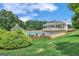 Beautiful community pool and clubhouse surrounded by lush landscaping on a sunny day at 425 Birkdale Dr, Fayetteville, GA 30215