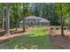 Charming two-story gray home with black shutters, a well-manicured lawn, and beautiful landscaping at 425 Birkdale Dr, Fayetteville, GA 30215