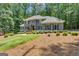 Beautiful two-story home with lush landscaping and mature trees at 425 Birkdale Dr, Fayetteville, GA 30215