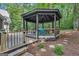 Gazebo on deck features backyard views and seating, surrounded by pine straw and trees at 425 Birkdale Dr, Fayetteville, GA 30215