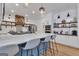 Open concept kitchen with gray cabinets, white countertops, stainless steel appliances, and bar stool seating at the island at 425 Birkdale Dr, Fayetteville, GA 30215
