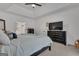 Bright primary bedroom featuring a king bed, ensuite, TV and carpet floors, providing a luxurious retreat at 425 Birkdale Dr, Fayetteville, GA 30215
