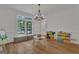 Bright playroom featuring hardwood floors, a large window with bench seating, and colorful storage for toys and art supplies at 425 Birkdale Dr, Fayetteville, GA 30215