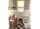 Small bathroom with dated wallpaper, vanity, toilet, and clawfoot bathtub at 301 Wedowee St, Bowdon, GA 30108