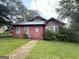 Home's front exterior features mature landscaping and a covered front porch at 301 Wedowee St, Bowdon, GA 30108