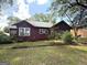 Charming home with mature trees in front yard with grass at 301 Wedowee St, Bowdon, GA 30108