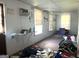 Bright living room with multiple windows, air conditioner and cluttered interior at 301 Wedowee St, Bowdon, GA 30108