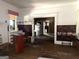 A living room with a fireplace, hardwood floors, and a glimpse into the adjacent rooms through the doorway at 301 Wedowee St, Bowdon, GA 30108