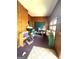 A room with wood paneled walls, with shelves and vintage furniture at 301 Wedowee St, Bowdon, GA 30108