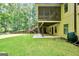 View of the backyard of the home, featuring stairs, woodshed, and rain barrel at 123 Eva Ln, Stockbridge, GA 30281