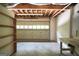 Unfinished basement with a workbench, storage shelves, and concrete flooring at 123 Eva Ln, Stockbridge, GA 30281