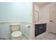 Bathroom with neutral fixtures and dark blue cabinets for storage at 123 Eva Ln, Stockbridge, GA 30281