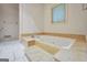 A jetted tub is featured in this bathroom with a tile floor and marble tub surround at 123 Eva Ln, Stockbridge, GA 30281