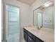 Bathroom with vanity, mirror, and adjoining room with a window at 123 Eva Ln, Stockbridge, GA 30281
