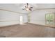 A spacious carpeted bedroom with a door to a balcony and a partial view of the bathroom at 123 Eva Ln, Stockbridge, GA 30281
