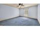 Bedroom features a ceiling fan and window with shutter-style blinds and blue carpet at 123 Eva Ln, Stockbridge, GA 30281