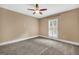 Bedroom with a ceiling fan and window with white shutter style blinds at 123 Eva Ln, Stockbridge, GA 30281