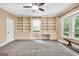 Large bonus room featuring a ceiling fan, built-in shelves, and desk areas at 123 Eva Ln, Stockbridge, GA 30281