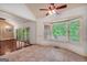 Bright breakfast nook with bay window, ceiling fan, and sliding doors to porch overlooking wooded backyard at 123 Eva Ln, Stockbridge, GA 30281