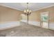 Traditional dining room with chandelier and neutral color palette, perfect for entertaining at 123 Eva Ln, Stockbridge, GA 30281