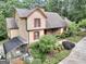 Charming home with red shutters, stone accents, lush landscaping, and attached greenhouse at 123 Eva Ln, Stockbridge, GA 30281