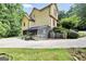 Exterior side view of the home with a greenhouse, lush greenery, and a well-maintained lawn at 123 Eva Ln, Stockbridge, GA 30281