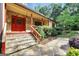 Inviting front entrance showing stone steps, a red door, flagstone landing and a lamp post at 123 Eva Ln, Stockbridge, GA 30281