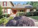 Inviting front porch with stone accents and a vibrant red front door at 123 Eva Ln, Stockbridge, GA 30281