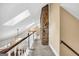 Hallway with vaulted ceilings and stone accent wall, connecting different areas at 123 Eva Ln, Stockbridge, GA 30281