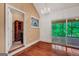 Hallway with wood floor, stained glass, access to a screened deck, and a decorative chandelier at 123 Eva Ln, Stockbridge, GA 30281
