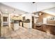 Bright kitchen featuring an island, tile floors and countertops, and access to a living area with a vaulted ceiling at 123 Eva Ln, Stockbridge, GA 30281