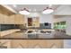 Kitchen island cooktop with granite countertops, stainless steel appliances, and custom tile backsplash at 123 Eva Ln, Stockbridge, GA 30281