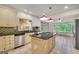 Bright kitchen with island cooktop, stainless steel appliances, and breakfast nook with scenic views at 123 Eva Ln, Stockbridge, GA 30281