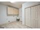 Spacious laundry room equipped with storage cabinets, utility sink, and tiled flooring at 123 Eva Ln, Stockbridge, GA 30281