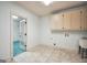 Bright laundry room with access to a walk-in closet offering ample storage at 123 Eva Ln, Stockbridge, GA 30281