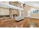 Expansive living room featuring a stone fireplace, hardwood floors, vaulted ceiling, and access to an outdoor deck at 123 Eva Ln, Stockbridge, GA 30281