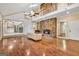 Open living room showcasing a stone fireplace, hardwood floors, vaulted ceiling, and access to the kitchen at 123 Eva Ln, Stockbridge, GA 30281