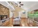 Well-lit living room with stone fireplace, vaulted ceiling, hardwood floors, deck access, and a decorative chandelier at 123 Eva Ln, Stockbridge, GA 30281