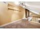 Carpeted loft area features a vaulted ceiling with unique stone accent wall at 123 Eva Ln, Stockbridge, GA 30281