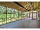 Enclosed porch with screens, ceiling fan, and wooded view at 123 Eva Ln, Stockbridge, GA 30281