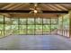 Large screened porch with beautiful wooded views and ceiling fan at 123 Eva Ln, Stockbridge, GA 30281