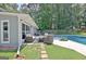 Inviting backyard with a sparkling pool, comfortable patio seating, and lush landscaping at 345 Summer Pl, Peachtree City, GA 30269